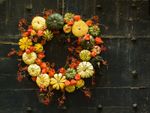 A Colorful Gourd Wreath Full Of Small Pumpkins
